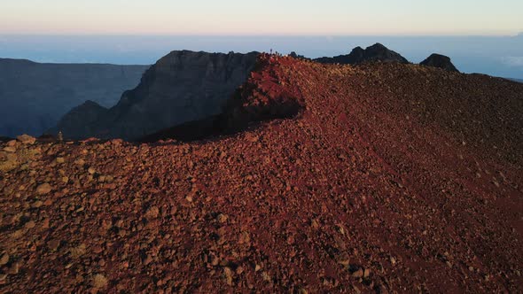 Drone footage of people at the summit of the Piton des Neiges while the sun rises on the Reunion isl