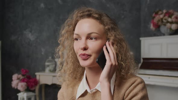 Close Up of a Young Caucasian Woman Shy Talking on a Phone