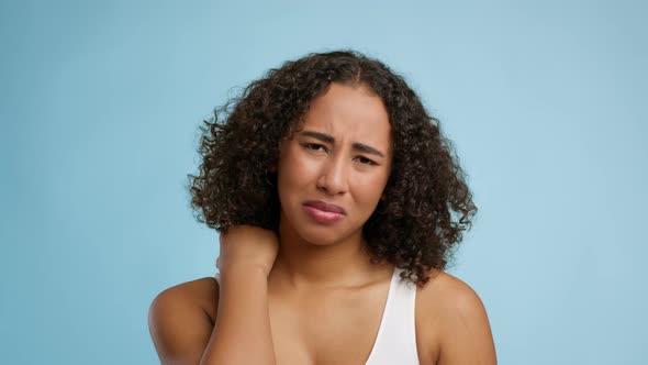 African American Lady Suffering From Nech Pain Over Blue Background