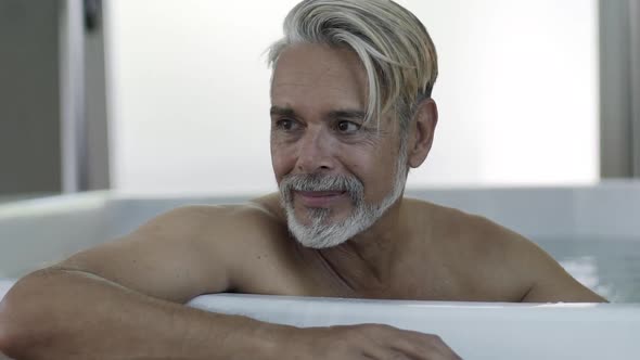 Portrait of man sitting in Jacuzzi