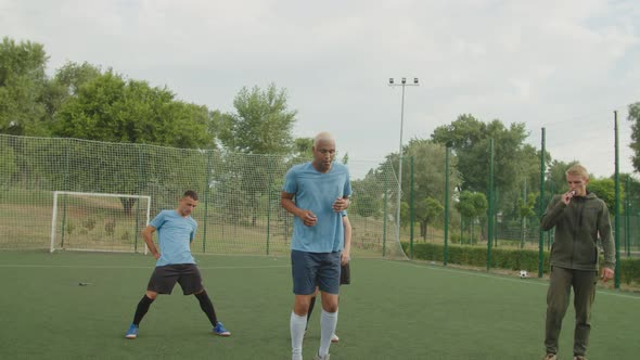 Soccer Player Jumping Barriers Performing Dribbling Exercise Outdoors