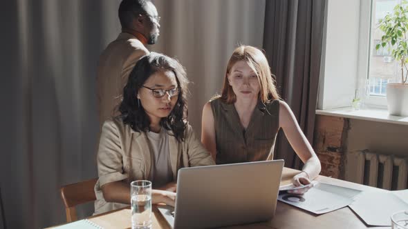 Young Women Working on Laptop at Modern Office