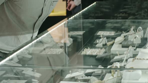 Man Choosing Engagement Ring on Luxury Shop Display