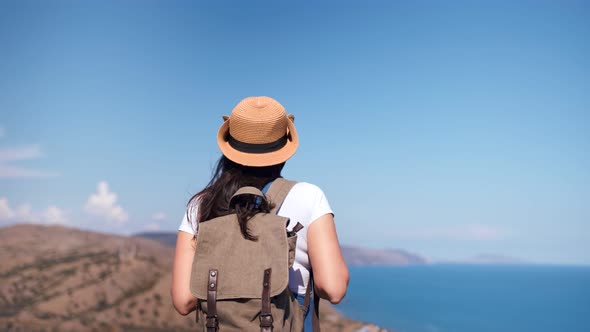 Back View Active Backpacker Woman Admiring Beautiful Seascape Approaching Top of Mountain