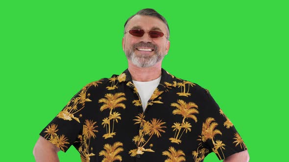 Successful Old Man in Sunglasses on a Vacation Looking To Camera on a Green Screen Chroma Key