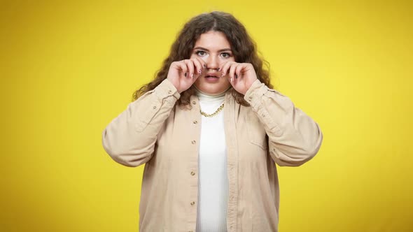 Portrait of Stressed Overweight Young Woman Looking at Camera Shaking Hands