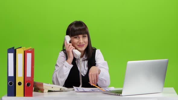 Girl Flirting on the Phone From the Workplace. Green Screen