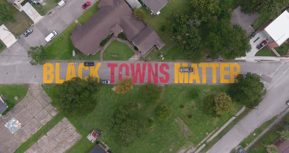 Bird eye view of a large "Black Towns Matter" sign painted on street in Houston Historical independe