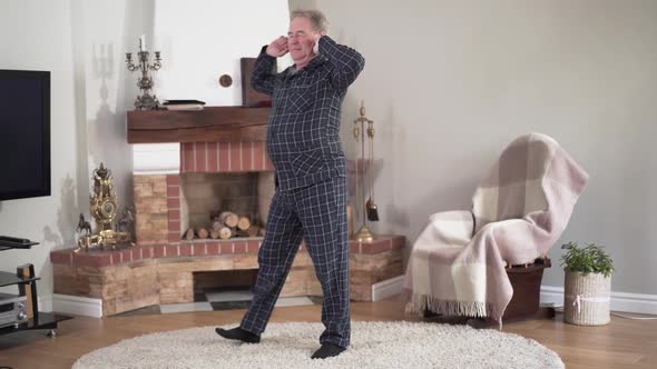 Portrait of Active Caucasian Senior Man Stretching and Doing Morning Exercises, Positive Elderly