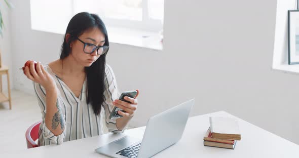 A Woman Freelancer Works at Home Using a Laptop