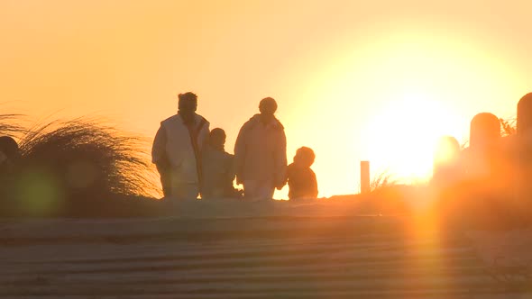 LS VIEW OF GRANDPARENTS WALKING ALONG A PATH WITH THEIR GRANDCHILDREN