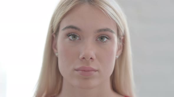 Close Up of Young Blonde Woman Looking at the Camera