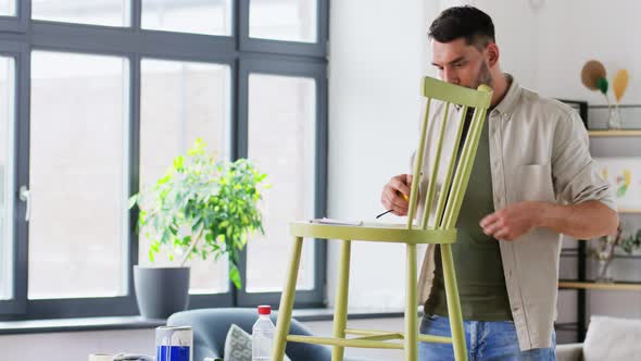 Man with Ruler Measuring Old Wooden Chair at Home