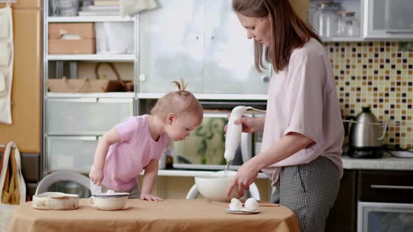 Little Cute Funny Girl Helping Mother Prepare Pie Cake in Kitchen Baking Homemade Cookie Together