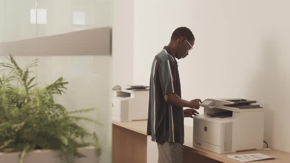 Man Using Xerox Copy Machine in Office