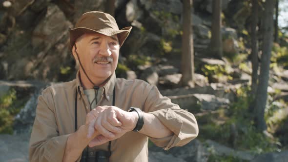 Senior Man Using Smartwatch during Hike