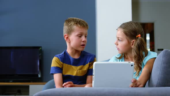 Siblings interacting with each other in living room