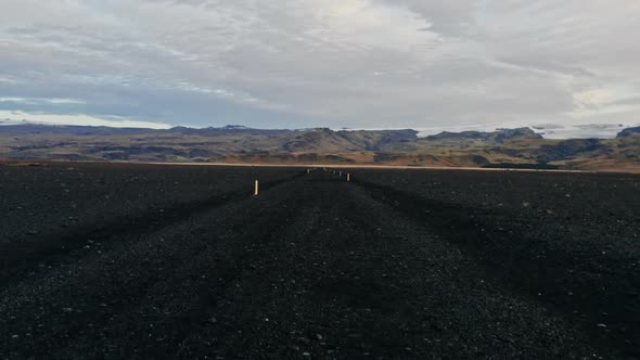 Drone Rising Over Black Sand Landscape