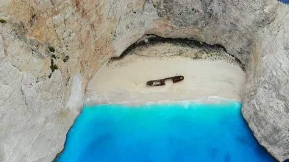 A Drone Flies Back Over Shipwreck Beach of Zakynthos Island on a Sunny Day