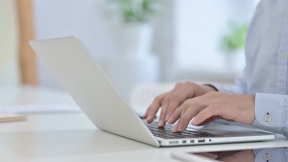 Close Up of Hands Typing on Laptop