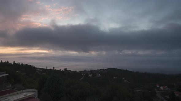 Clouds moving fast over Caramulo valley at sunrise, Portugal. Timelapse