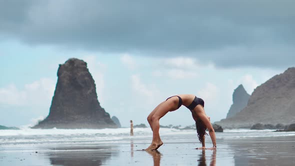 Calm Girl Is Meditating in the Mountains, Bright Sunshine on the Background. In Slow Motion Video