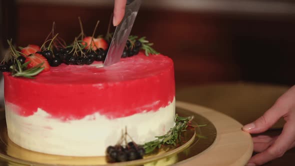 Woman Is Cutting Creamy Cake with Berries and Herbs, Close-up of Hands