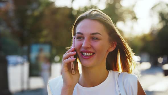 Cheerful Woman Talking on Phone on Street