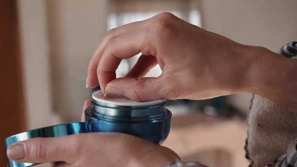 Women's Hands Open a Jar of Face Cream