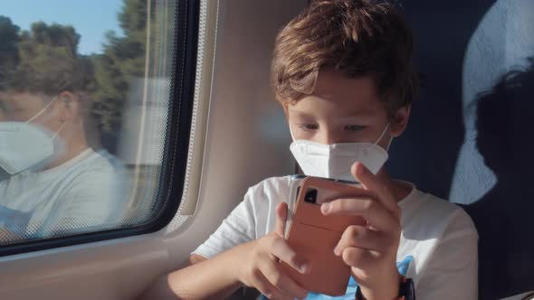 Boy Filling in Journey Time By Playing Mobile Games