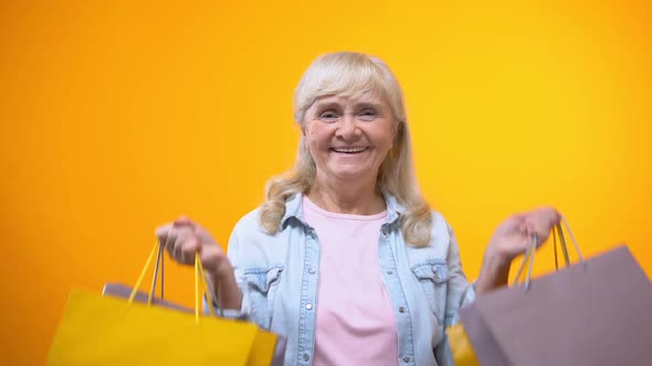 Joyful Senior Female Holding Shopping Bags, Pleasant Leisure Time, Advertisement