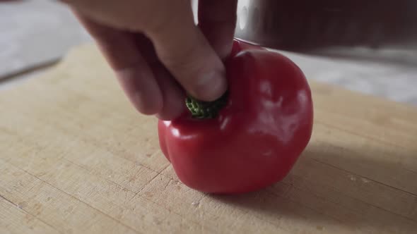 Man Cuts Red Pepper with Knife