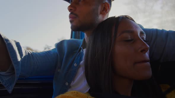 Young couple on a road trip in their pick-up truck