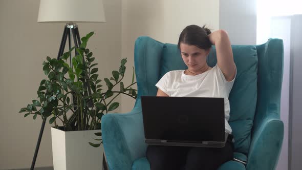 Authentic Young Woman Chatting On Laptop In Living Room