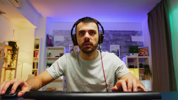 Pov of Young Man with Headphones Playing Games