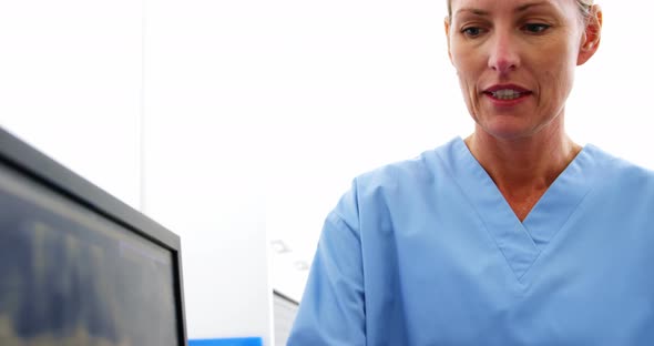 Dentist and dental assistant discussing a x-ray on the monitor