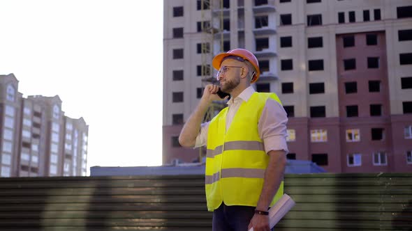 Worker Talks on His Phone About Important Project