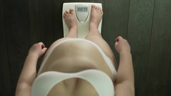 Top View of Woman on Scales with Word Diet on Screen, Health Problem, Overweight