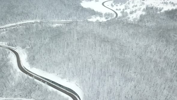 Drones Eye View  Winding Road From the High Mountain Pass in Winter