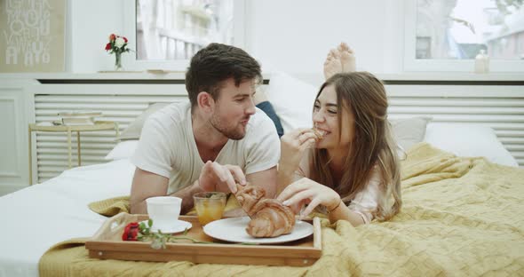 In the Morning a Cute Couple Have Breakfast in Bed