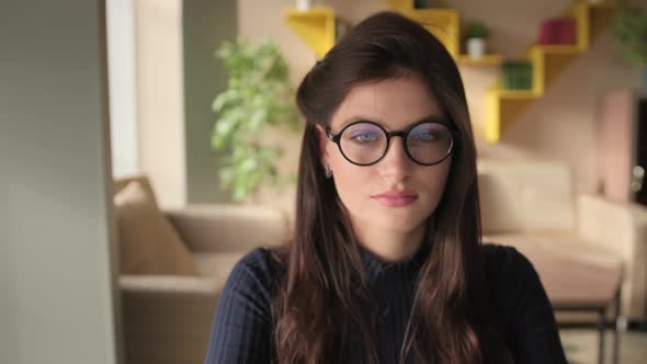 Young, Beautiful Woman Is Reading a Book in a Library. Student and Learning Concept.