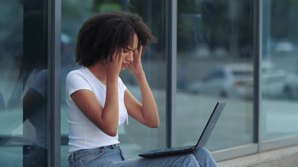 Young Beautiful Ethnic African American Woman Working at Laptop in City. Suddenly Feeling Sickness