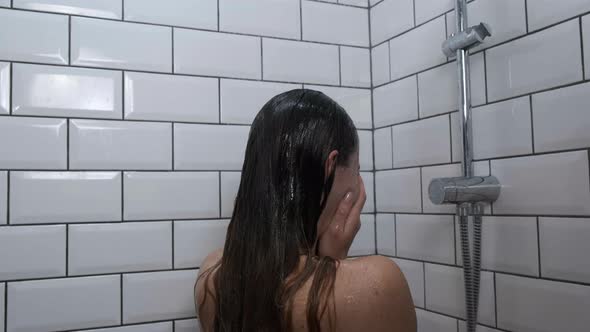 Sad Depressed Girl Crying in Shower Under Running Water Back View Close Up