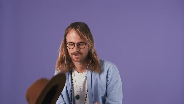 Young Man in Blue Shirt Glasses and Bijouterie