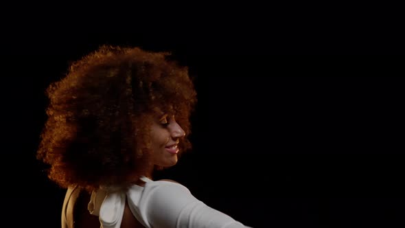 Portrait of Charming African American Woman Enjoys Music and Dancing on Stage