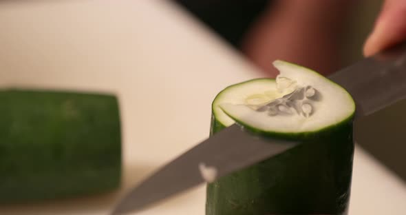 Slicing Fresh Cucumber Vertically By A Sharp Kitchen Knife. - High Angle Shot