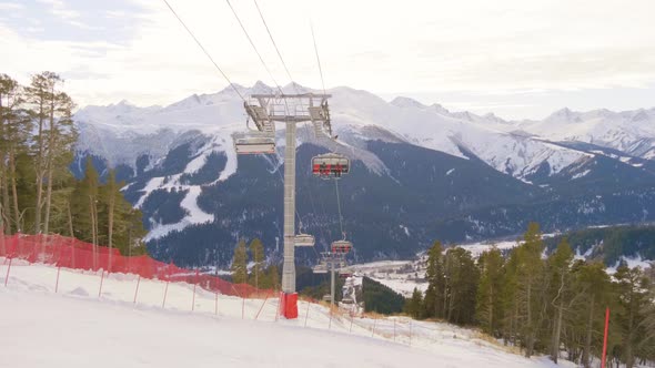 Winter Panorama with Ski Lifts and Snow Covered Mountains on a Sunny Day
