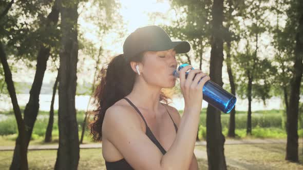 Sporty Girl Drinking Water From a Sports Bottle