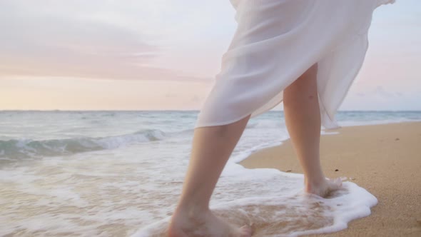 Close Up Woman Feet Walking Barefoot By Beach in Sunset Light Slow Motion Waves