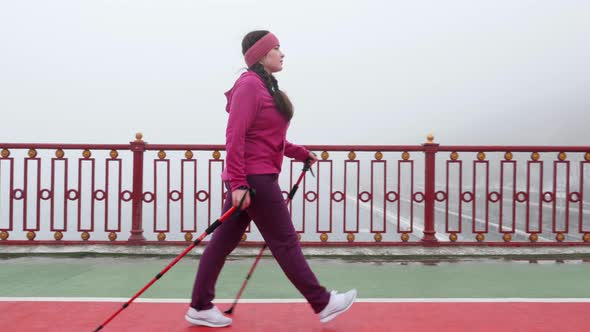 Nordic Walking Concept. Young Chubby Caucasian Woman Hiking with The Nordic Poles